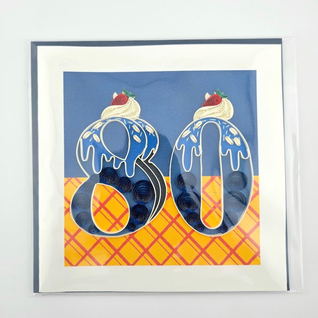 Framed artwork with decorative numbers '80' resembling ice cream cones on a blue and yellow checkered background.