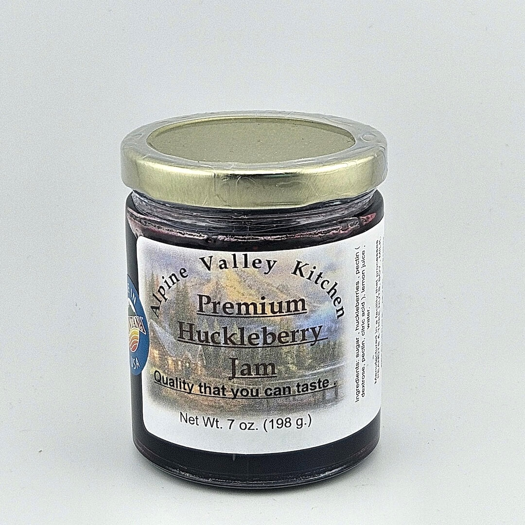 Glass jar with gold lid. White label has mountain cabin landscape in background of printed product info.