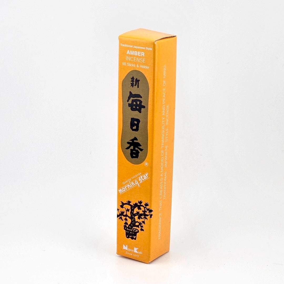 light orange box of 50 incense sticks with Japanese writing above bonsai tree packaging on gray background.