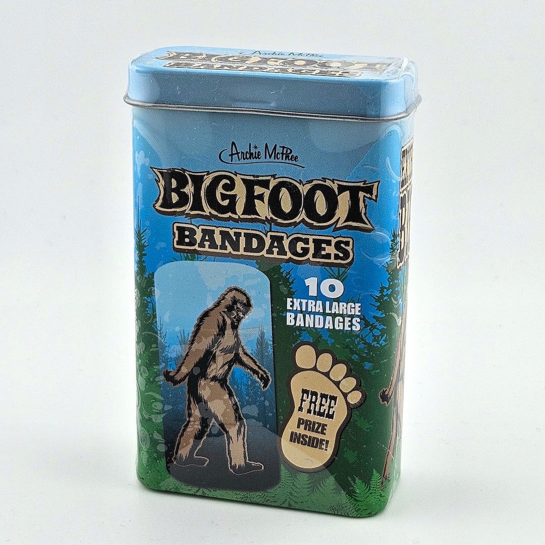 Tin box of Bigfoot bandages with a cartoon Sasquatch and forest design on a white background