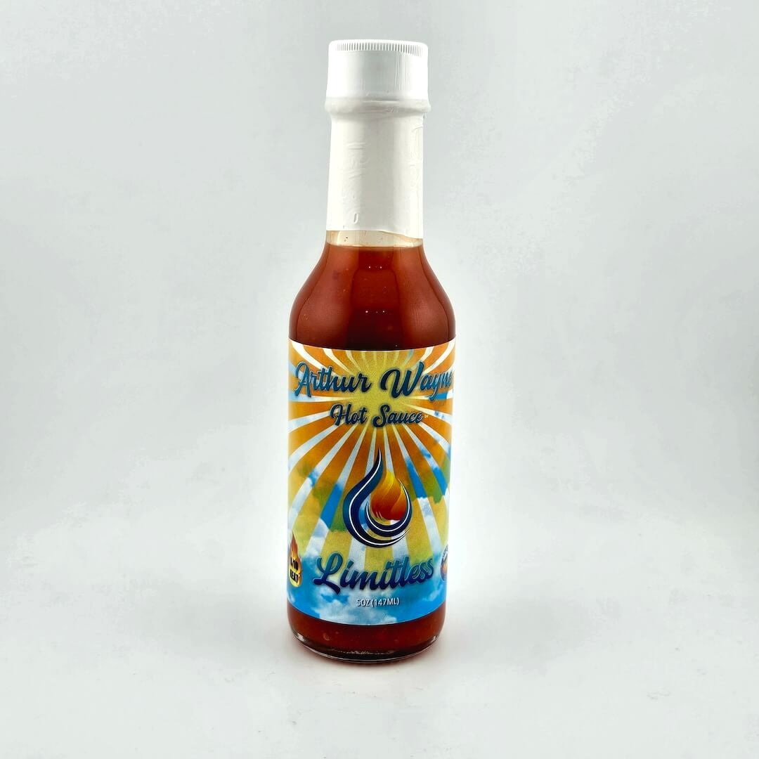 Glass bottle of hot sauce safety sealed with plastic. Label across main body of bottle details flavor and image depicting it.