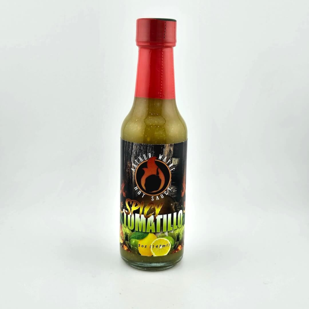 Glass bottle of hot sauce safety sealed with plastic. Label across main body of bottle details flavor and image depicting it.