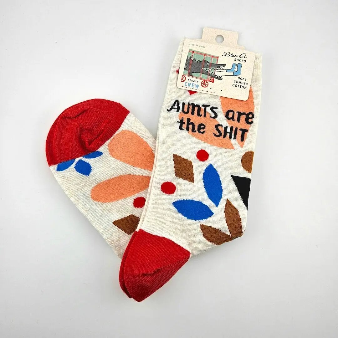 Colorful socks with abstract patterns and text on a white background