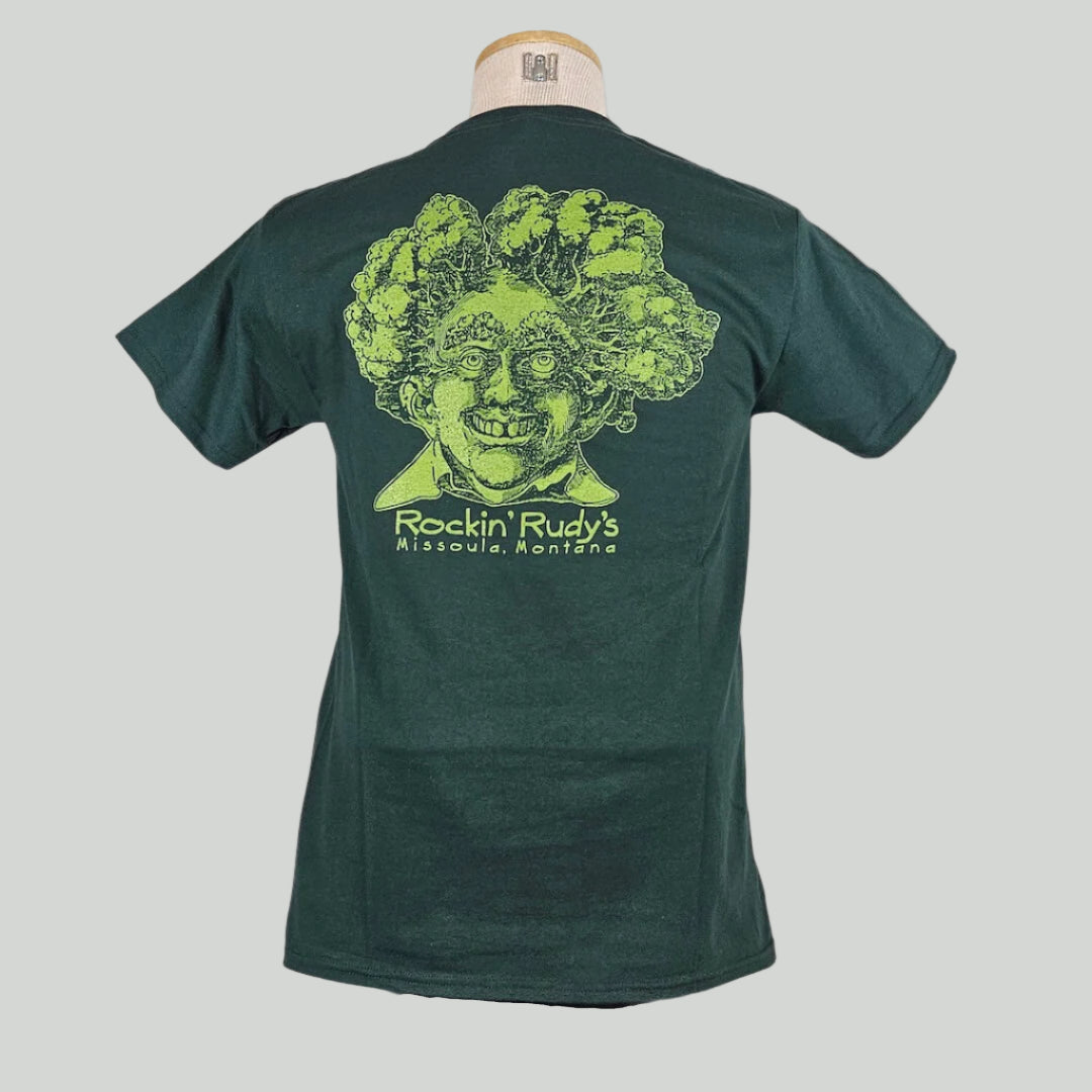 Green shirt with large smiling man’s head with trees for hair, "Rockin Rudy's, Missoula, Montana," printed below in center.