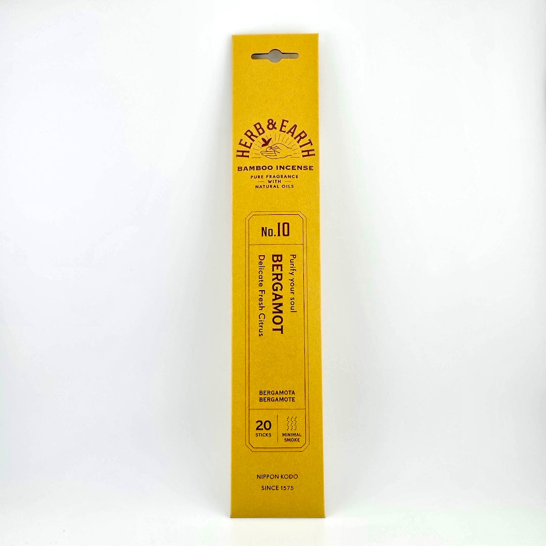 Golden yellow rectangular package of incense with brown text describing product.