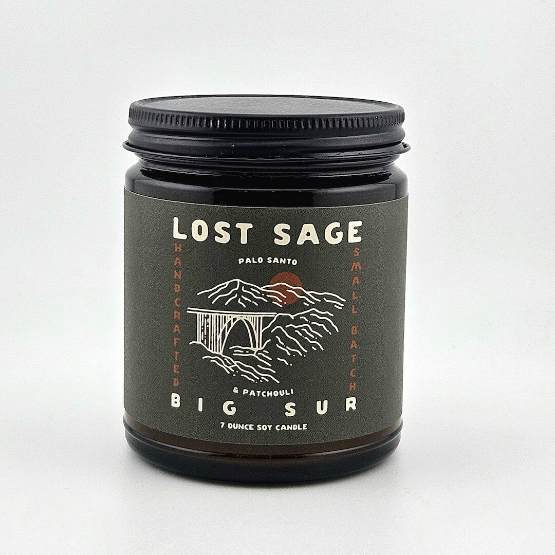 Candle jar labeled 'Lost Sage, Big Sur' on a white background