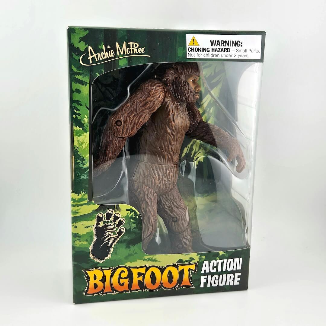 Boxed Bigfoot action figure with warning label on a white background