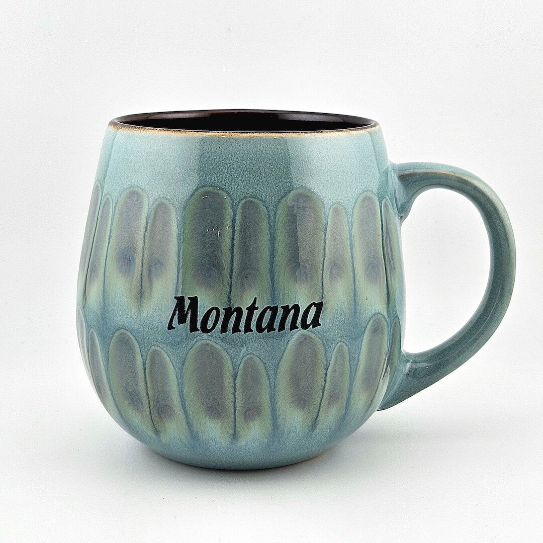Blue ceramic mug with 'Montana' text on a white background