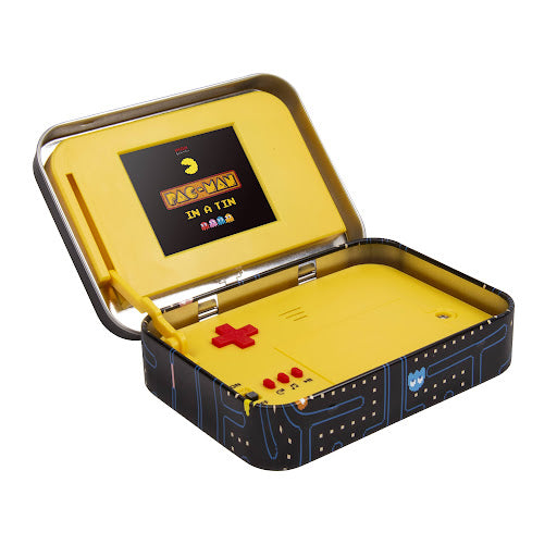 open tin with yellow pac-man game inside against white background