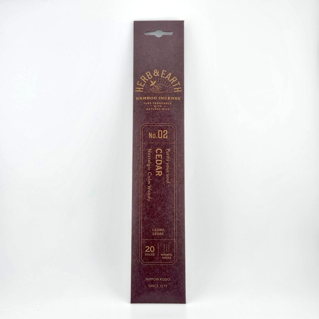Maroon-brown rectangular package of incense with brown text describing product.