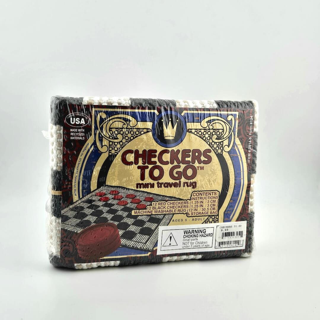 Packaged 'Checkers to Go' mini travel rug with checkered design on a white background