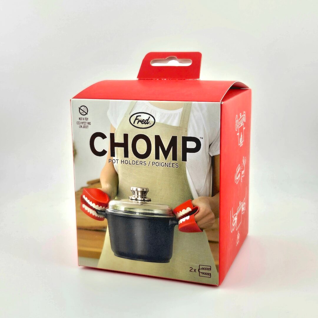 Red packaging for teeth shaped pot holders against white background.
