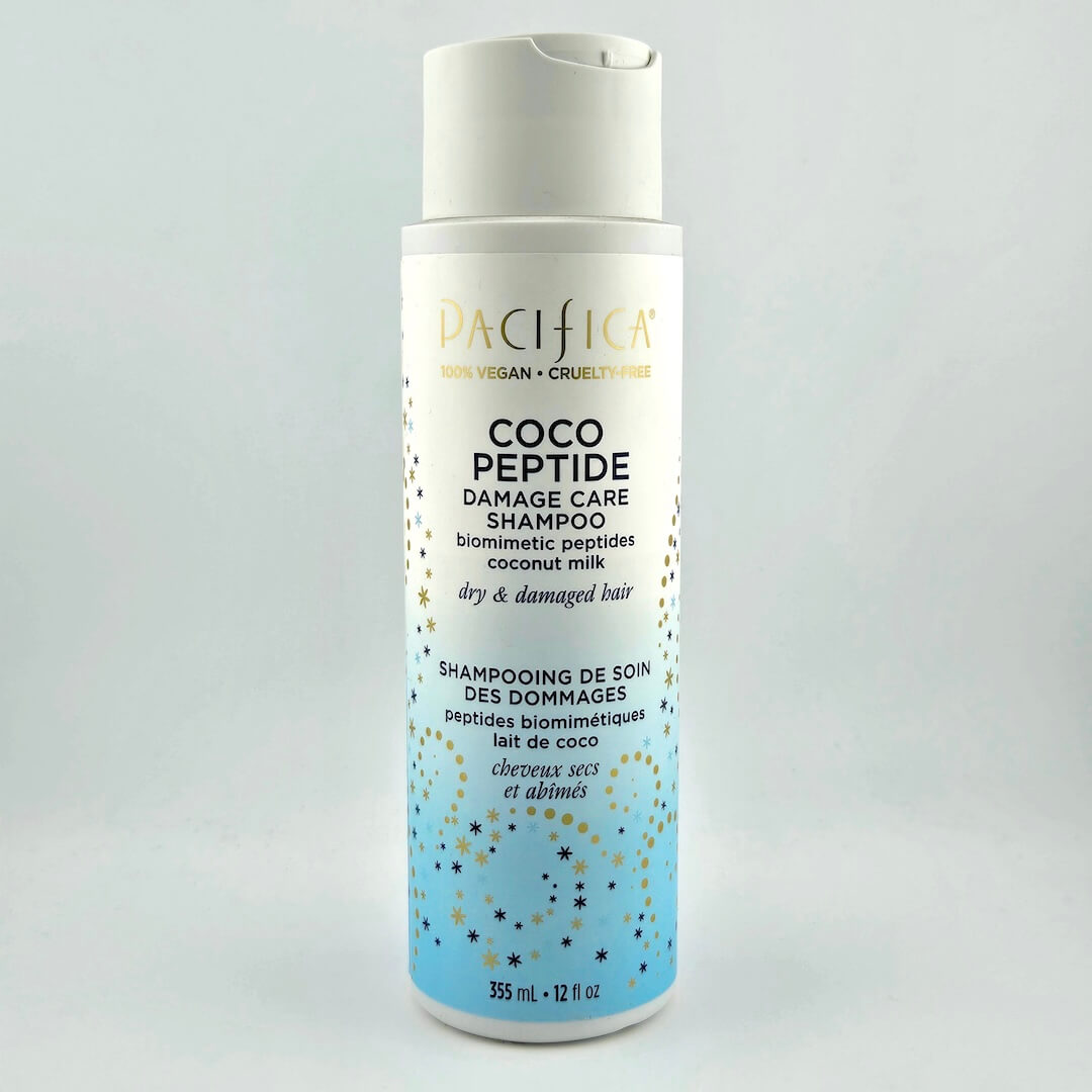 Shampoo bottle labeled 'Coco Peptide Damage Care Shampoo' by Pacifica on a light gray background