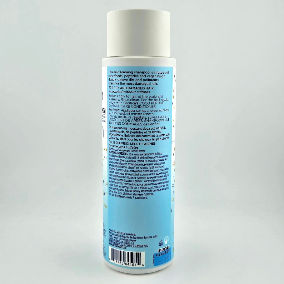 Shampoo bottle with blue label on a gray background