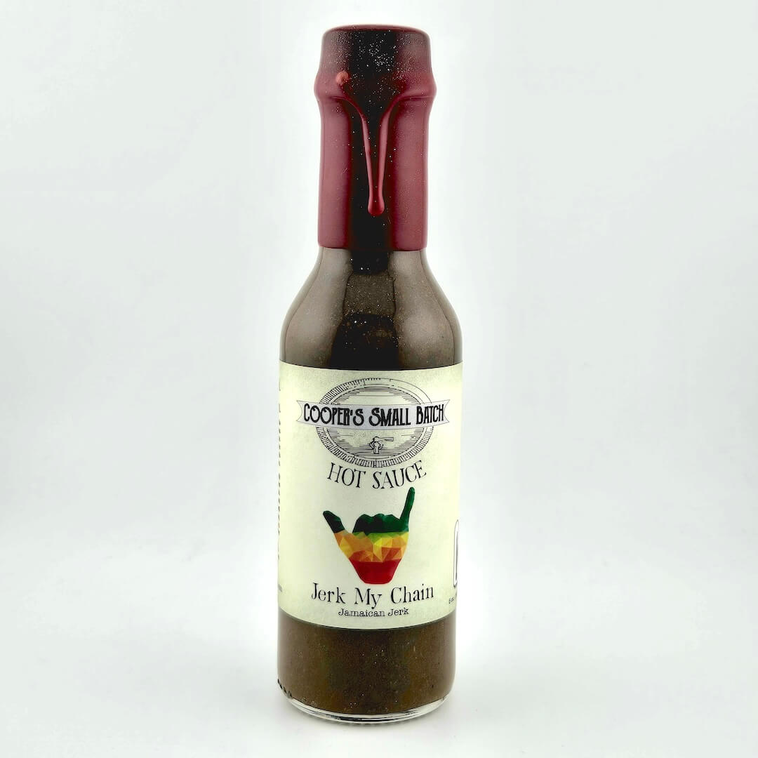 Bottle of 'Jerk My Chain' hot sauce with a red cap on a white background