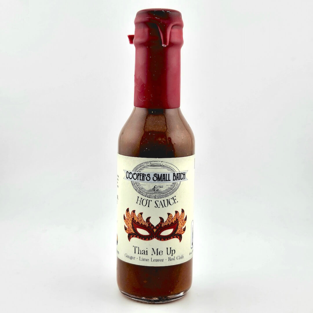 Bottle of Coover's Small Batch Hot Sauce with a red cap on a white background