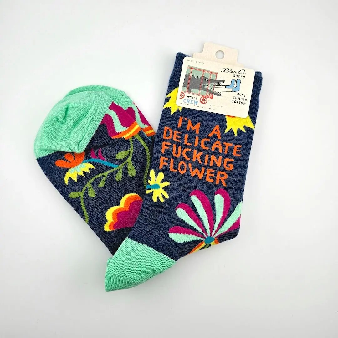Colorful socks with floral patterns and text on a white background