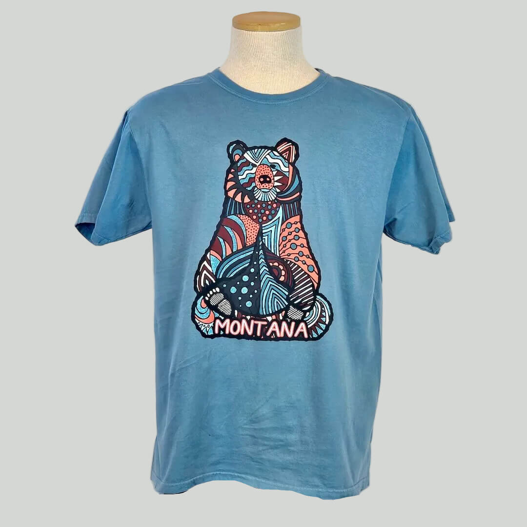 Blue t-shirt with a bear graphic and 'Montana' text on a mannequin against a white background