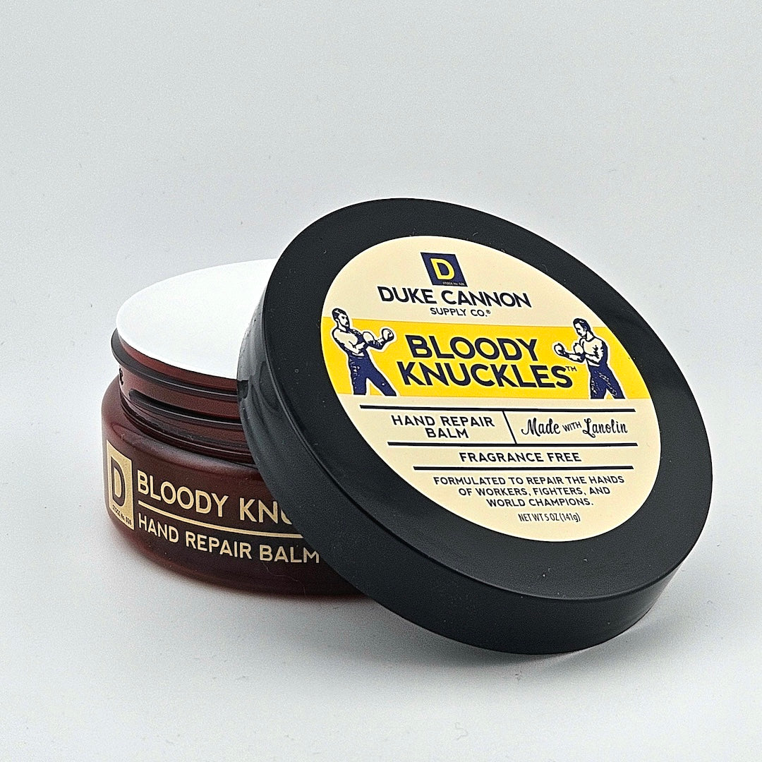 Tub container for hand repair balm against white background.