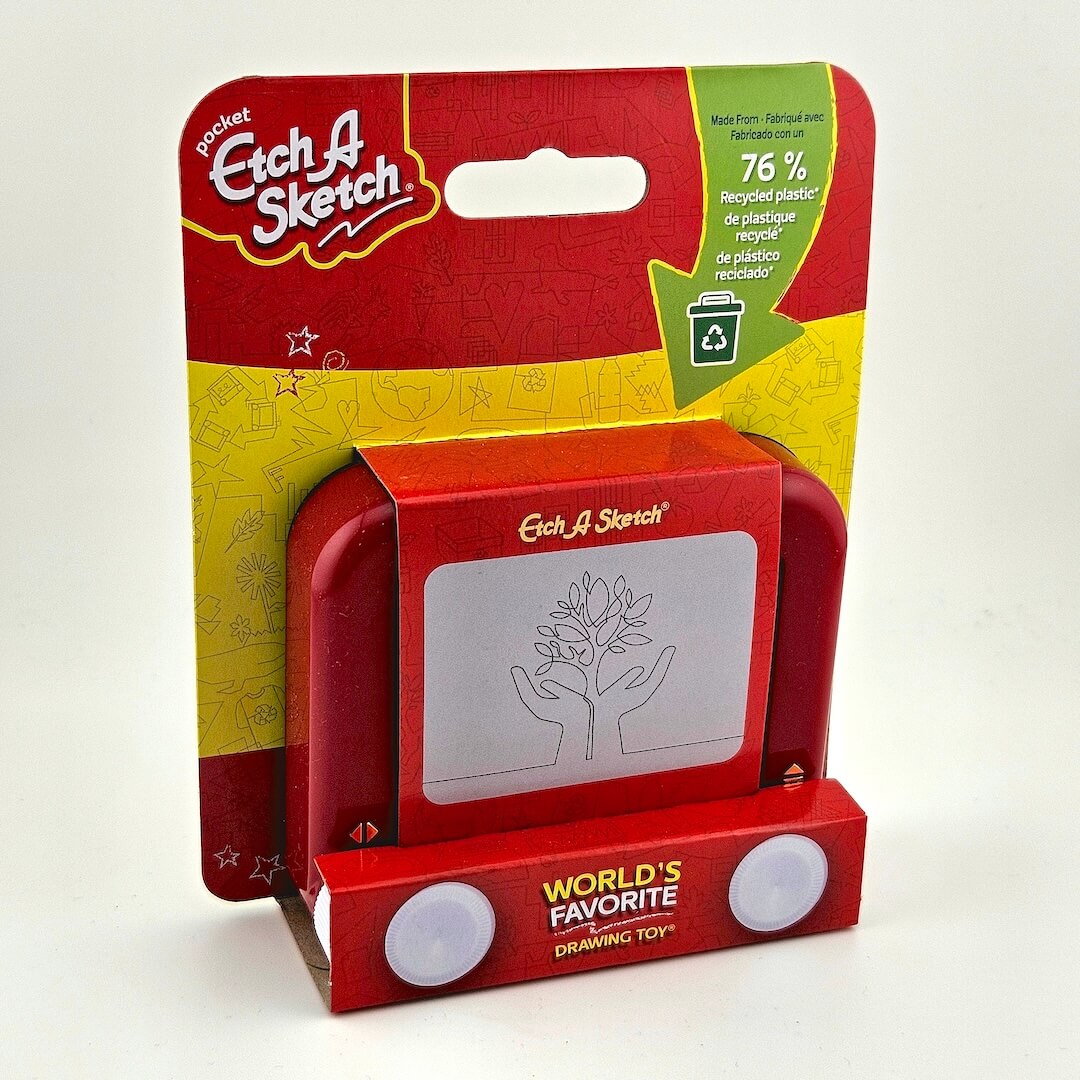 Red Etch A Sketch toy in its packaging with visible branding and recycling information.