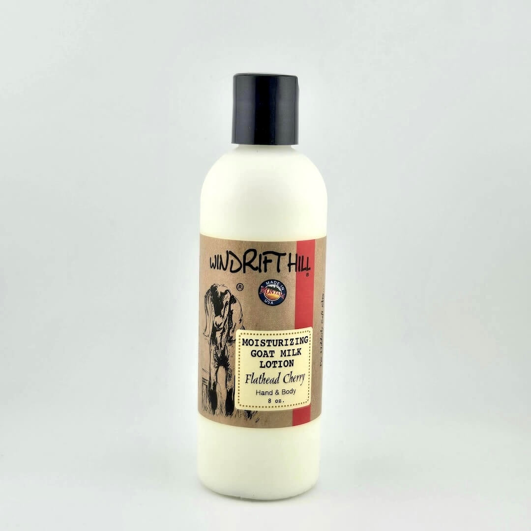 Plastic bottle of Windrift Hill moisturizing goat milk lotion on a gray background