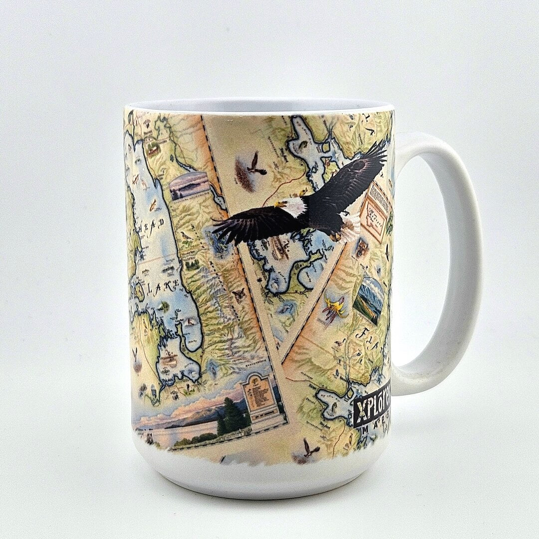 White mug with map and animal design against white background.
