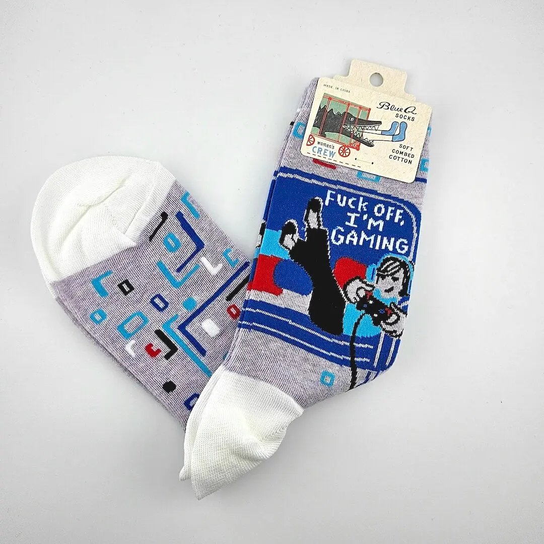 Two pairs of socks with graphic designs on a gray background