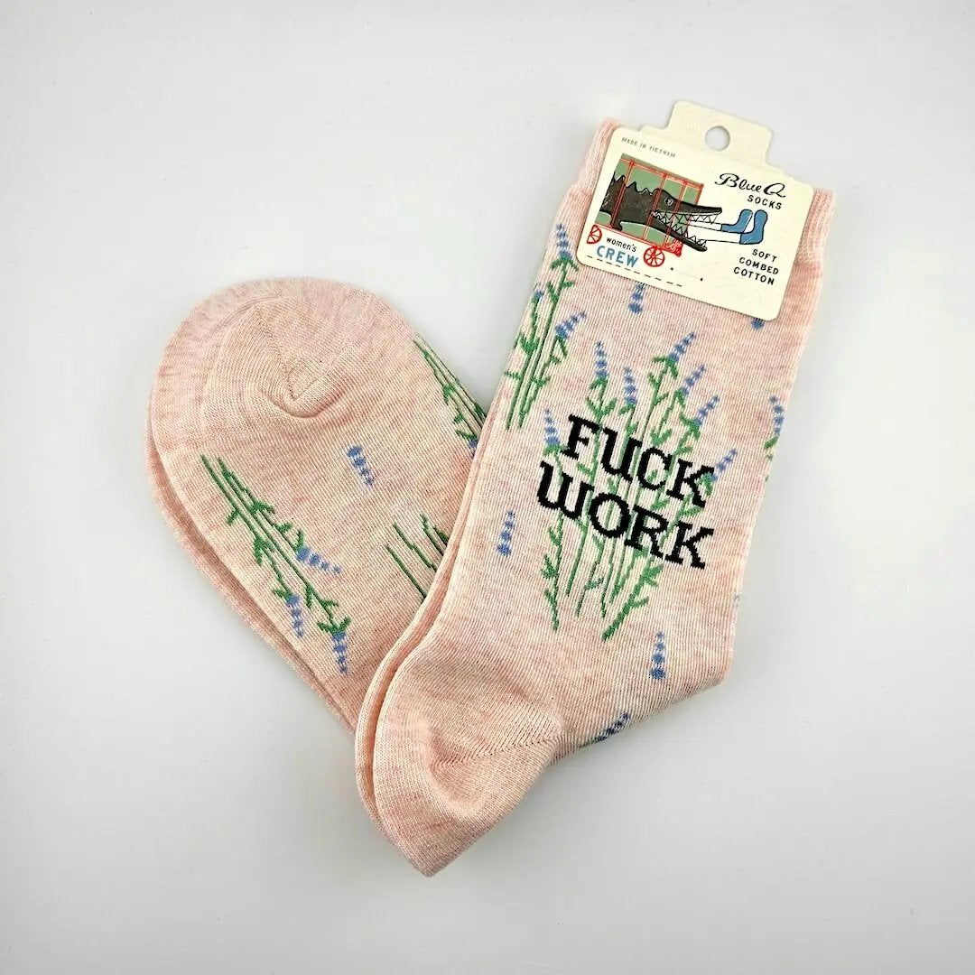 Pink socks with floral designs and 'F*ck Work' text on a light gray background