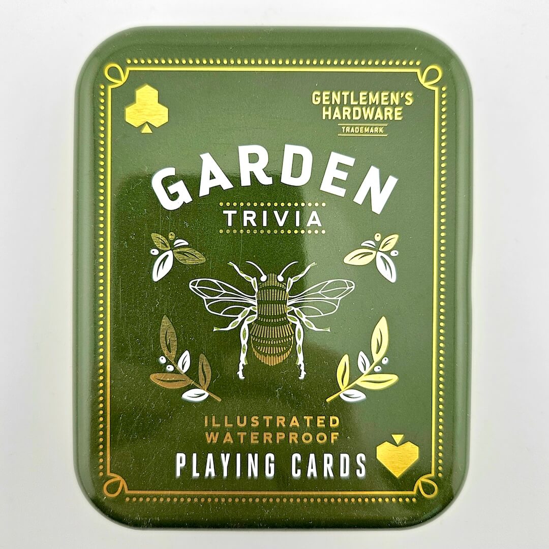 Green packaging of 'Garden Trivia' playing cards with a bee illustration on a white background