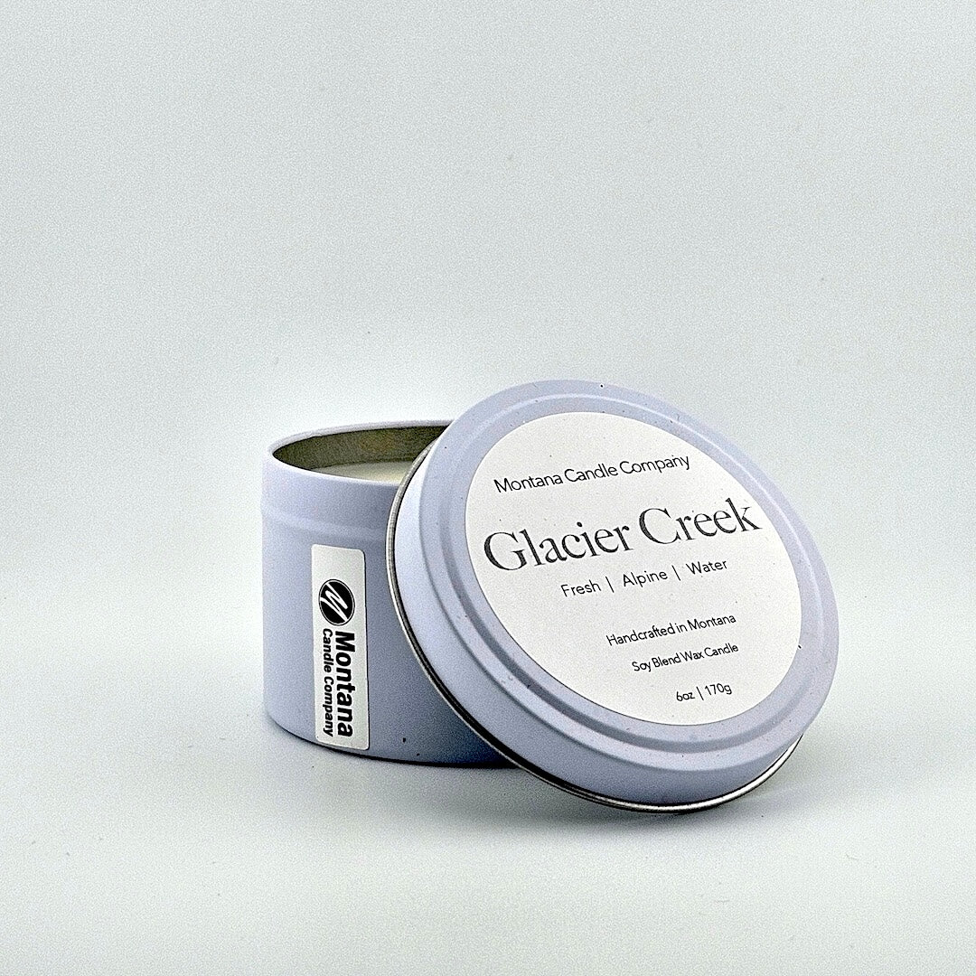 Lavender tin candle with lid, label with printed scent name at top then listed scent components then more details below.