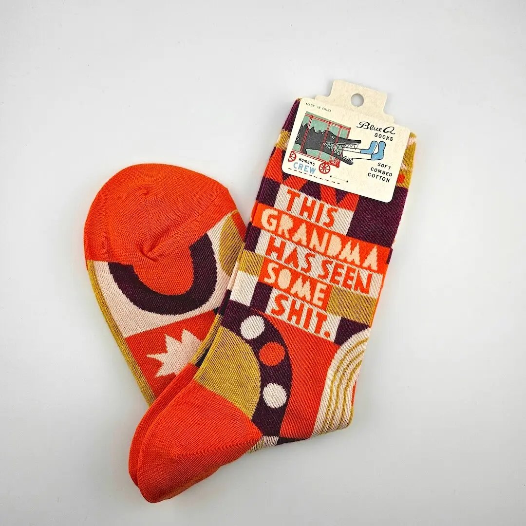 Colorful socks with a humorous message on a white background