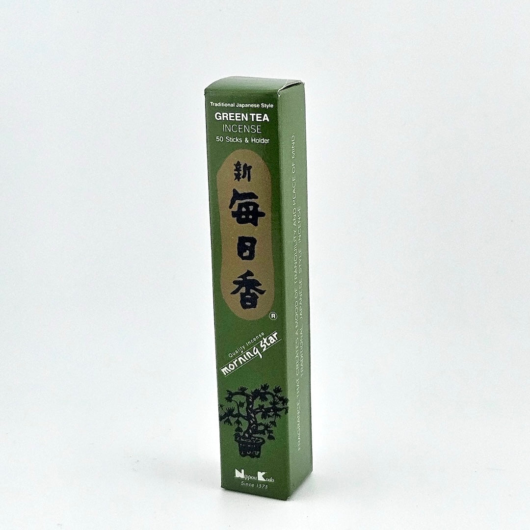 Green box of 50 incense sticks with Japanese writing above bonsai tree.