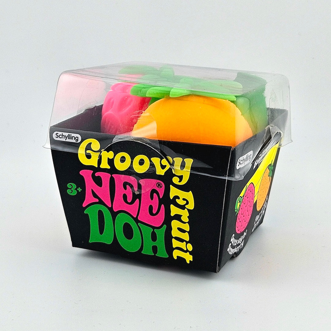 Packaged toy fruit set with colorful packaging on a white background