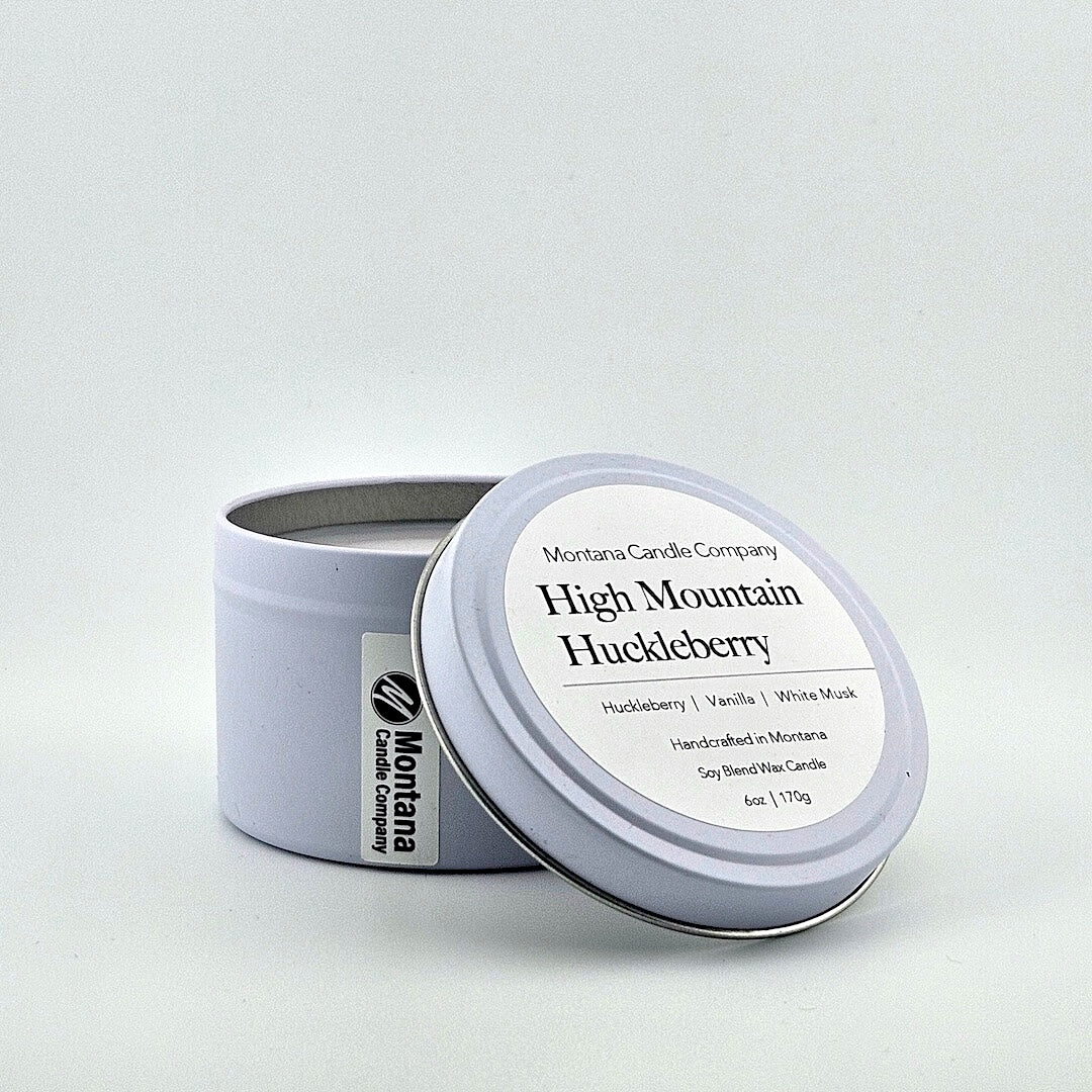Lavender tin candle with lid, label with printed scent name at top then listed scent components then more details below.