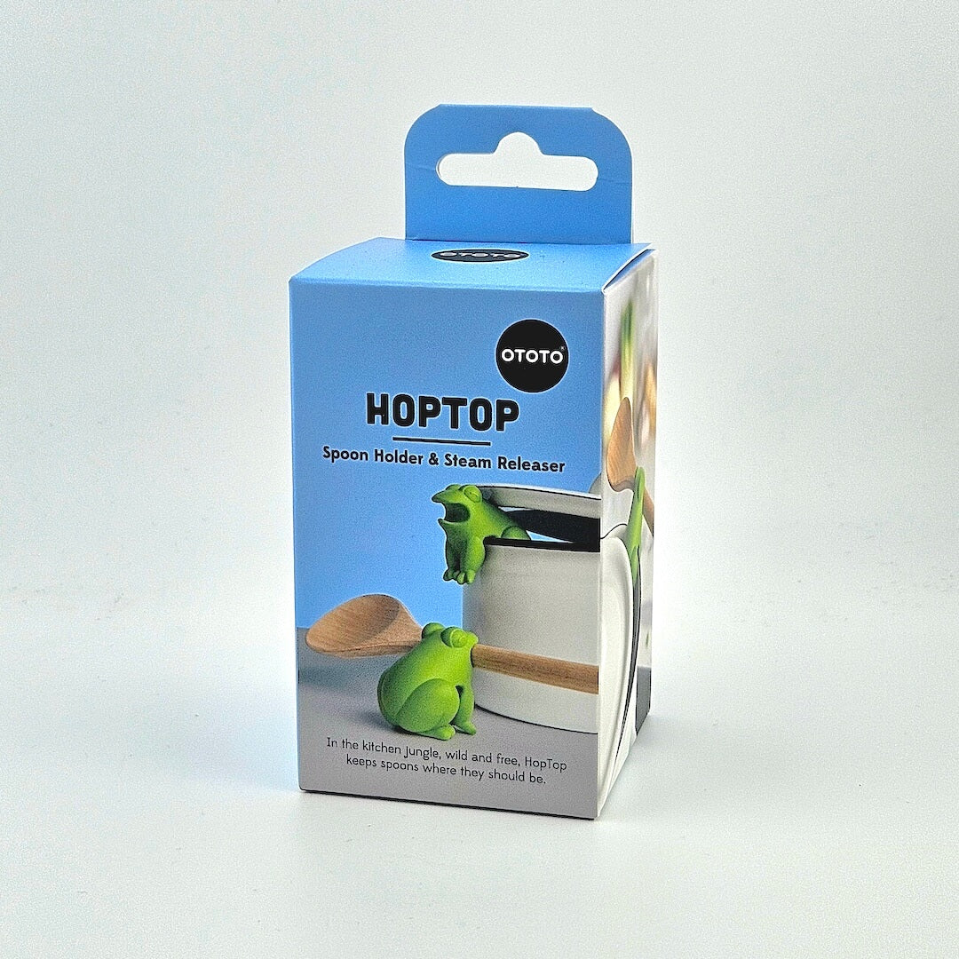 Blue box for frog shaped spoon holder and steam release against white background.