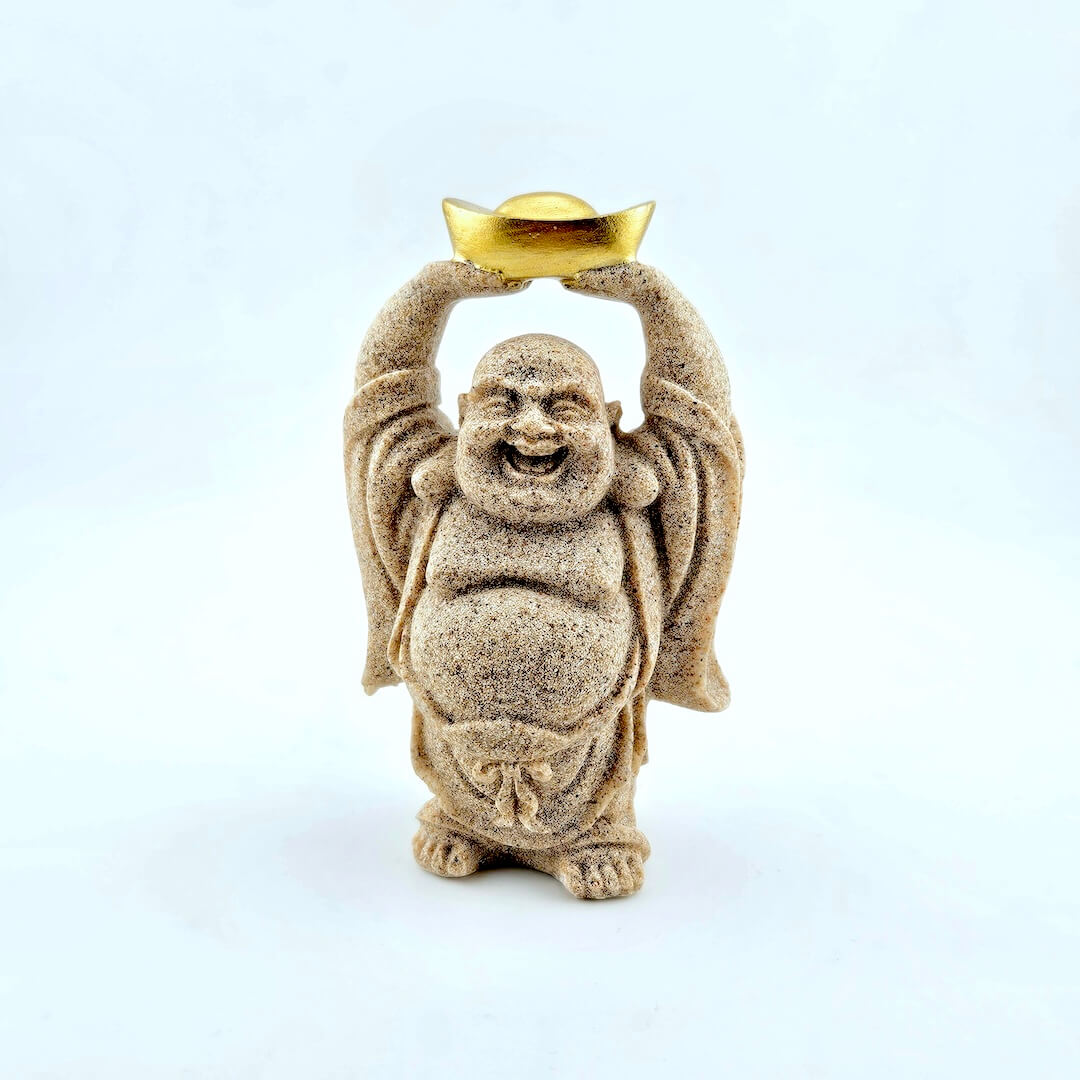 Statue of a laughing Buddha holding a gold coin on a white background