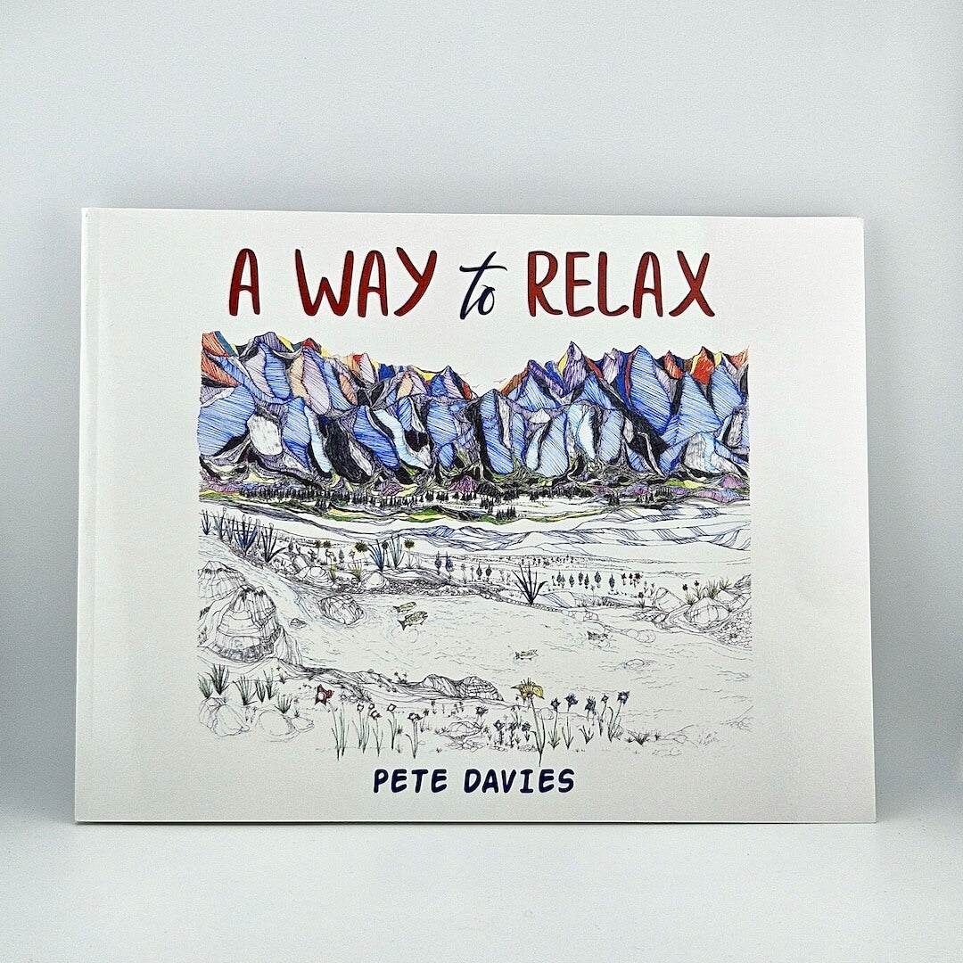 Book with mountain landscape illustration against white background.