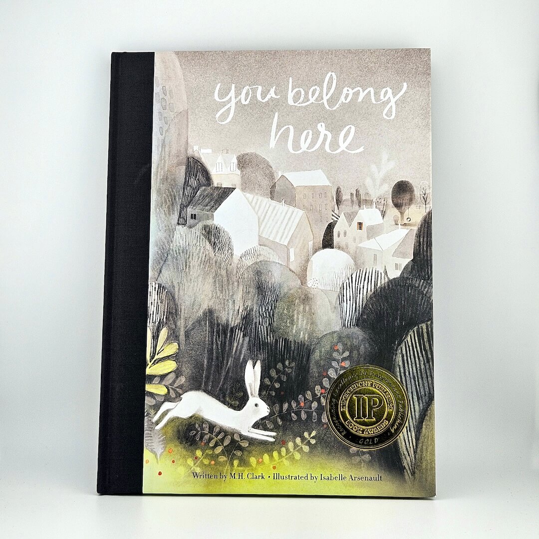 Hardcover book with artistic landscape illustration as cover