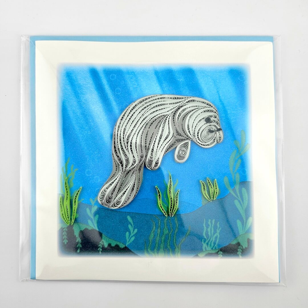 Manatee illustration on a blue underwater background with green seaweed.