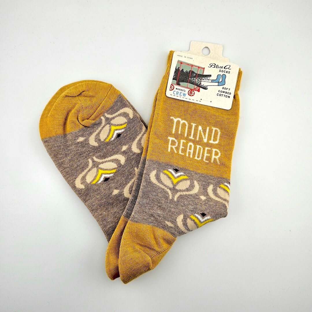 Pair of socks with 'Mind Reader' text on a white background