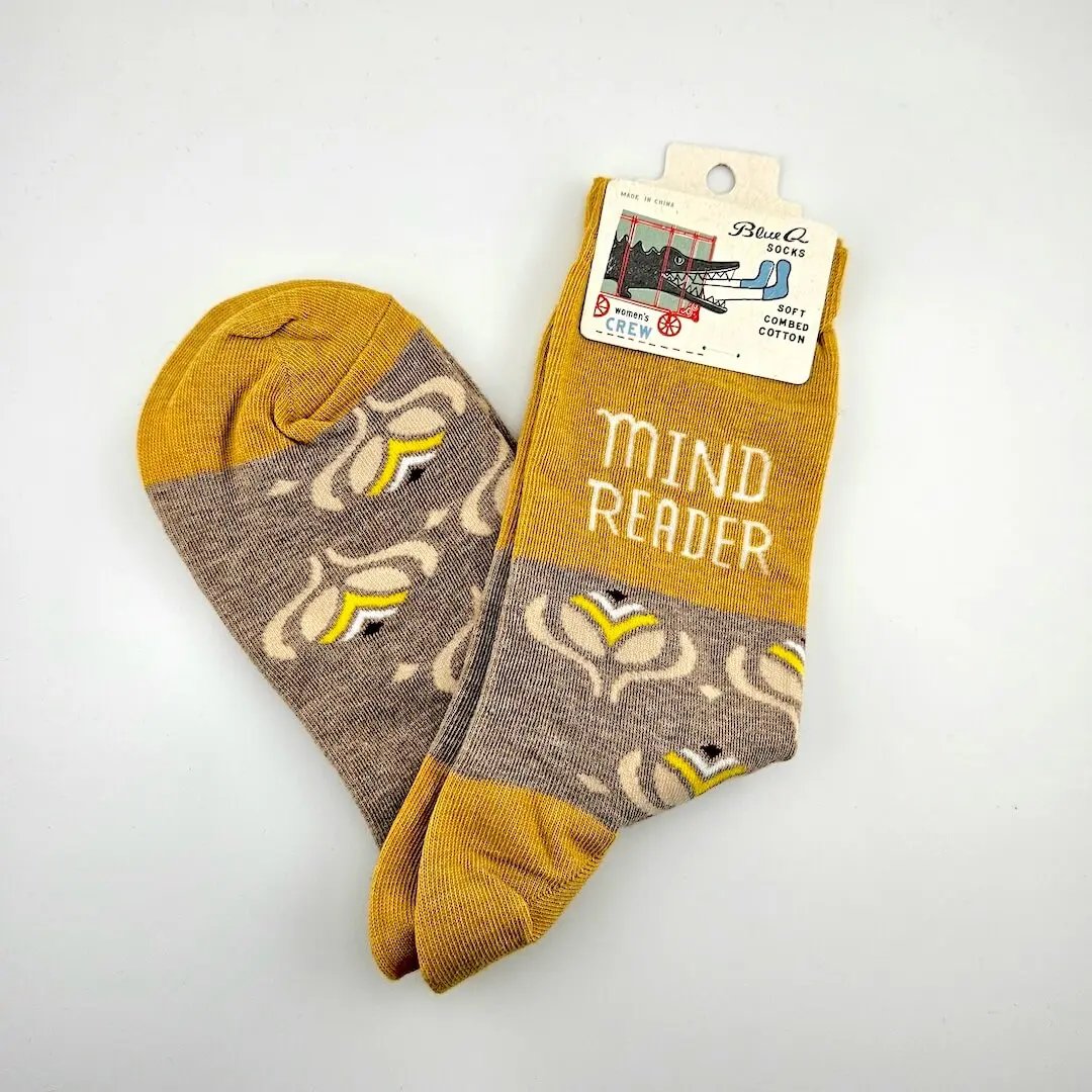Pair of socks with 'Mind Reader' text on a white background