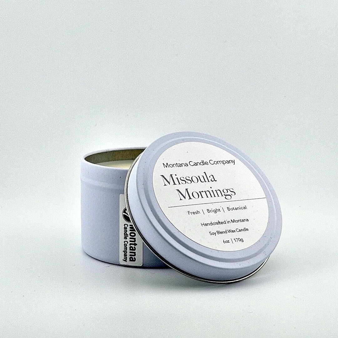Lavender tin candle with lid, label with printed scent name at top then listed scent components then more details below.