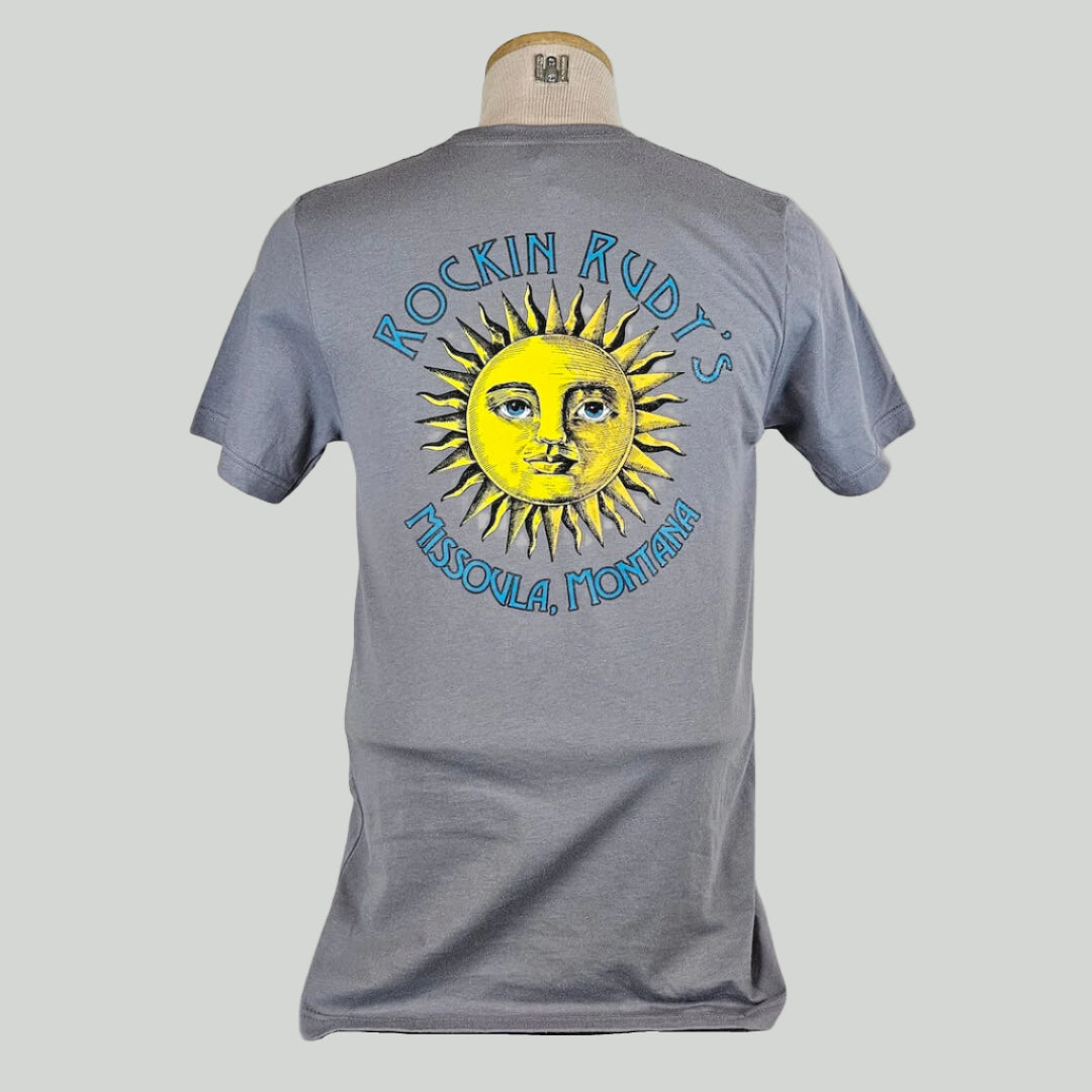Gray t-shirt with large sun in center with "ROCKIN RUDY'S" & "MISSOULA, MONTANA" encircling it.