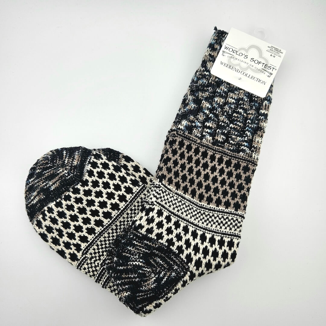 Black and white patterned sock with a visible brand label on a light gray background