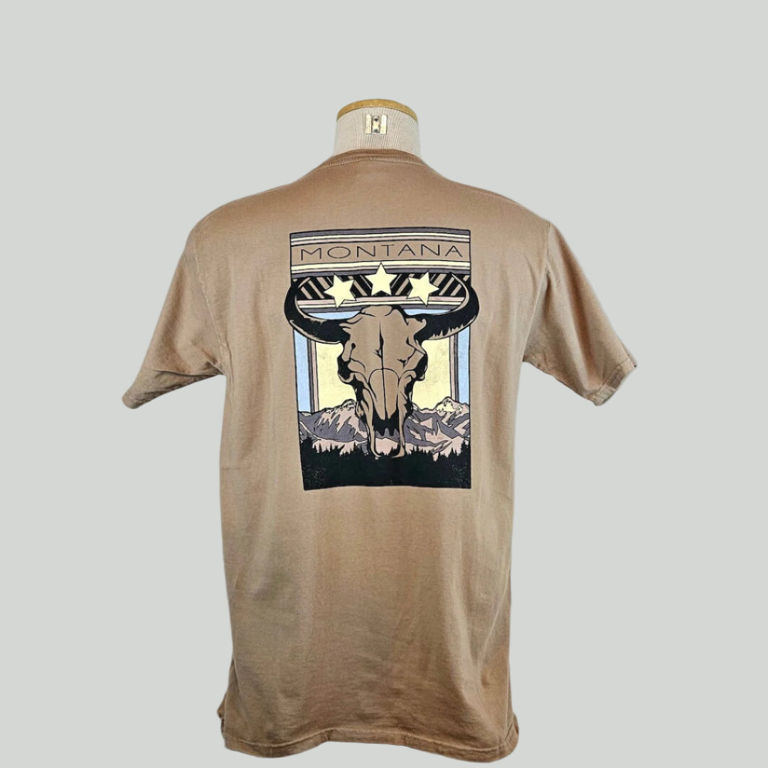 Beige t-shirt with a graphic design on the back featuring a skull and mountains, displayed on a mannequin against a light gray background.
