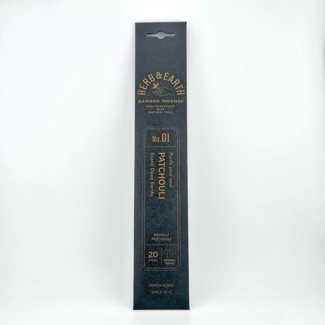 Black rectangular package of incense with brown text describing product.