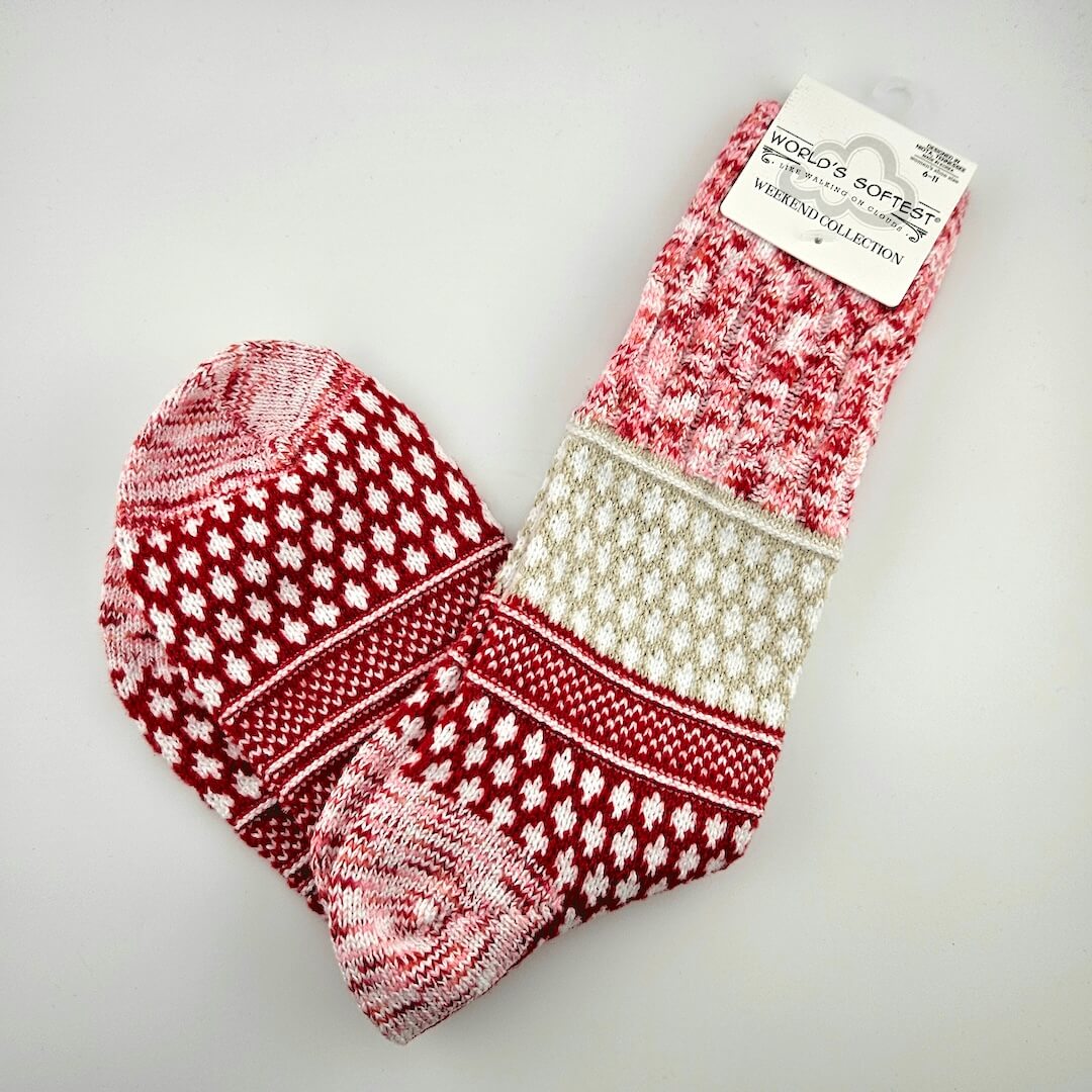 Pair of red and white patterned socks on a gray background