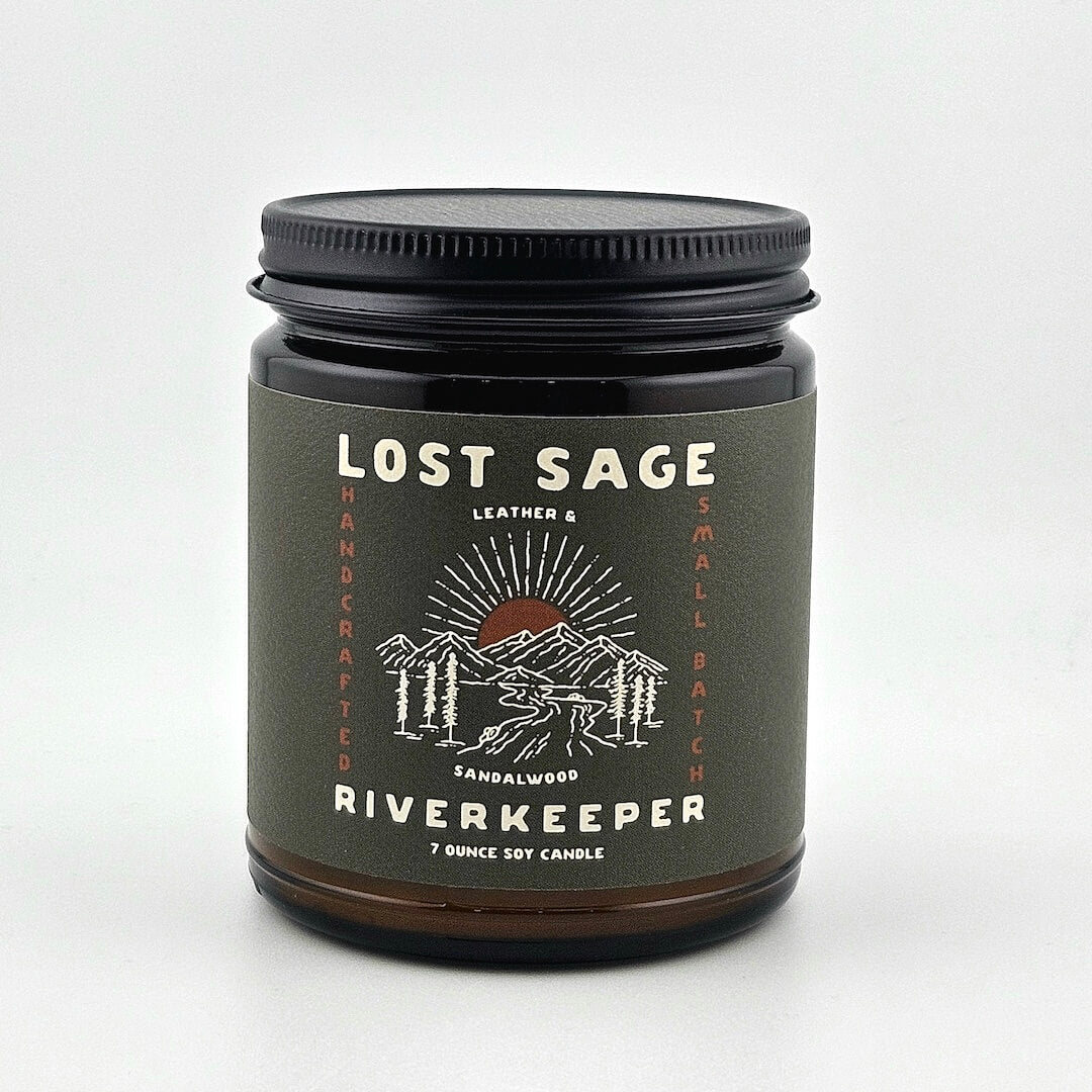 Candle jar labeled 'Lost Sage Riverkeeper' on a white background
