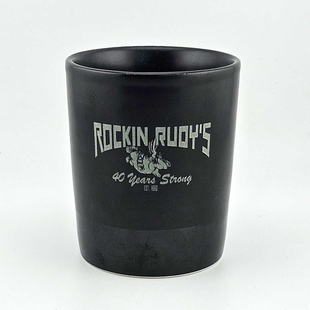 Black mug with 'Rockin Rudy's 40 Years Strong' text on a white background