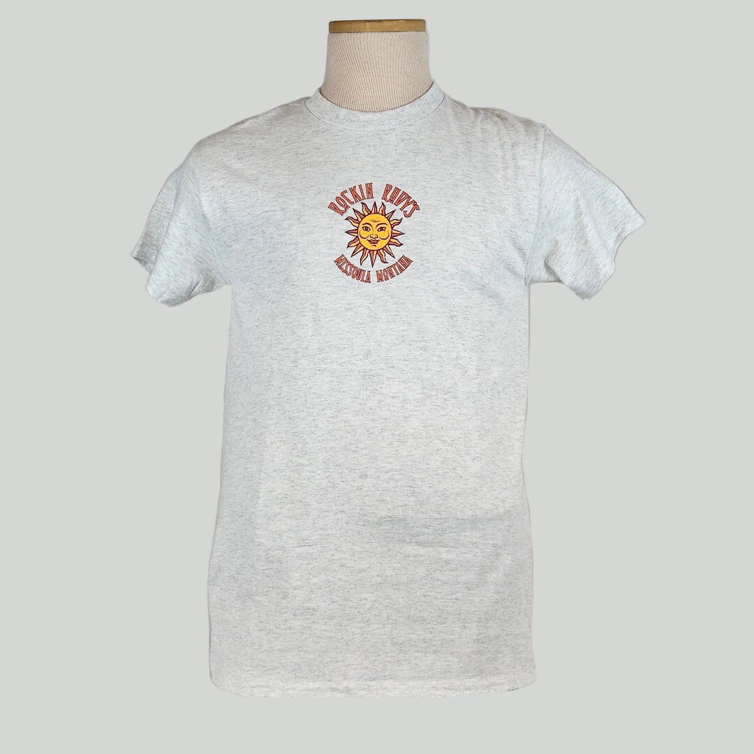 Heathered gray colored t-shirt with small sun in center with "ROCKIN RUDY'S" & "MISSOULA, MONTANA" encircling it.
